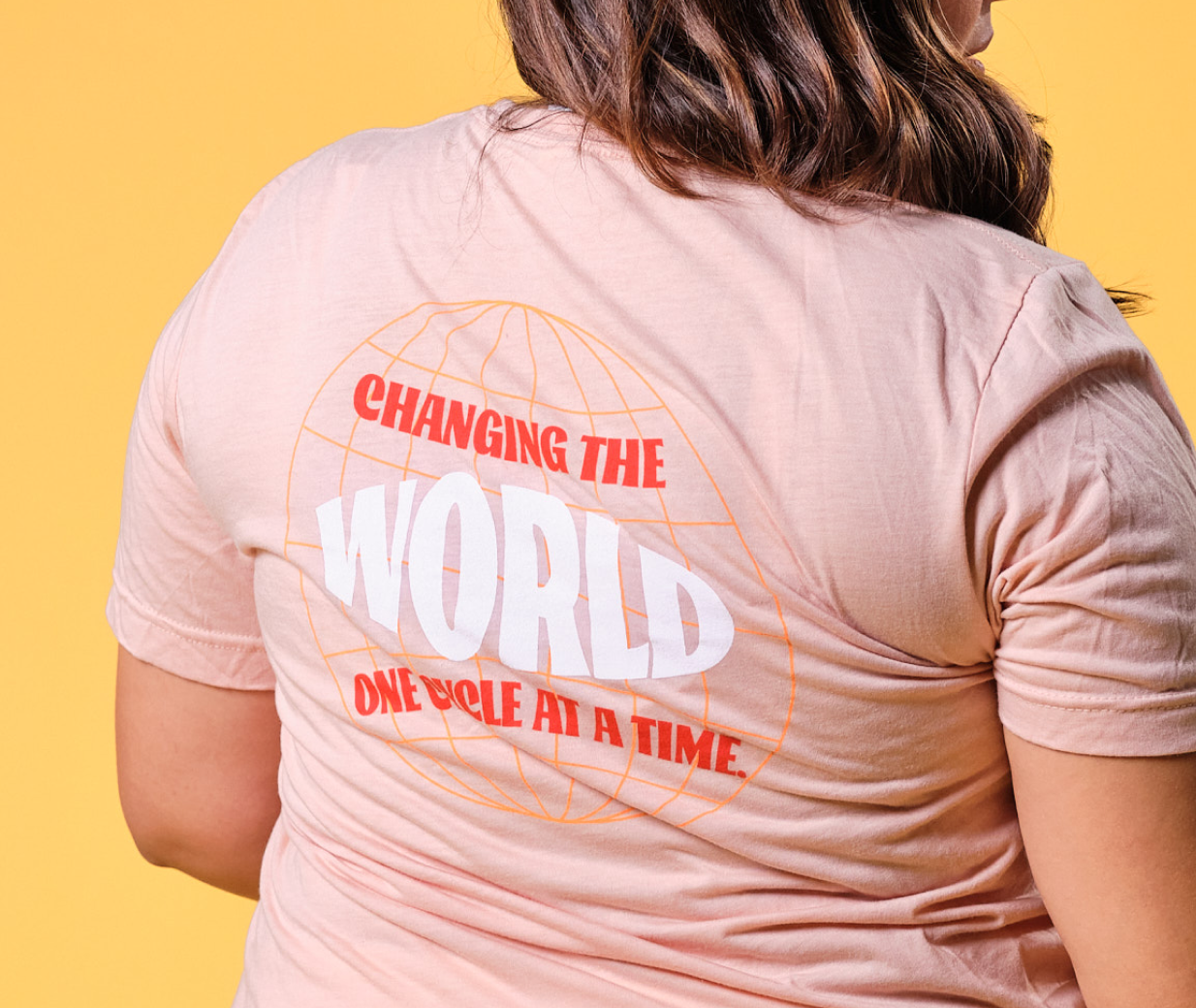 Back of Changing the World, One Cycle at a Time® Tee